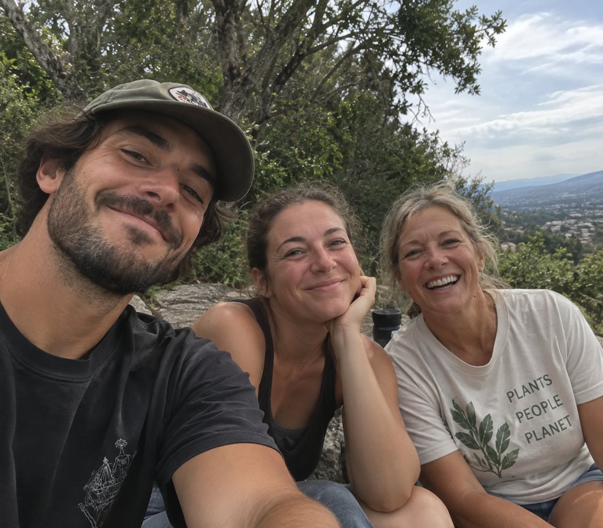 The Viora Veg family smiling outdoors on a hillside